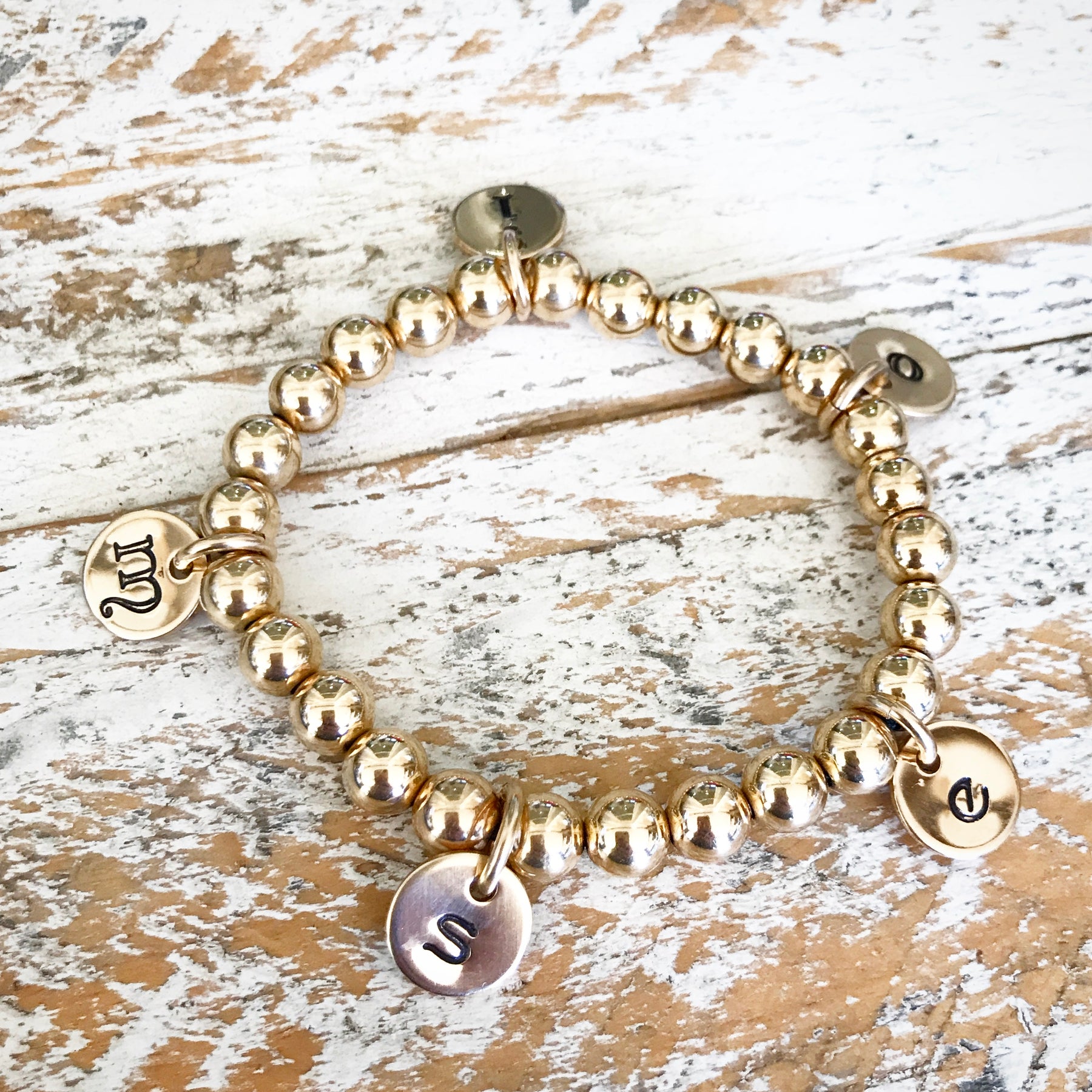Gold beaded deals bracelet with charm